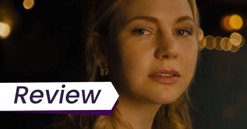 Still from the Swearing Jar, which Alex Heeney reviews. Adelaide Clemens appears in close-up looking into lens against a backdrop of blurred golden lights.
