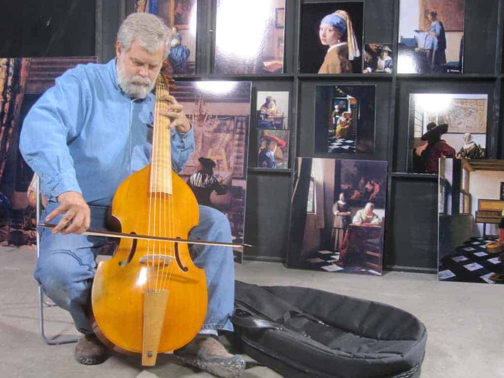 In his warehouse in San Antonio, Texas, Tim Jenison plays the viola de gamba he used to furnish his Vermeer room. Photo by Natalie Jenison, © Tim Jenison, Courtesy of Sony Pictures Classics. 