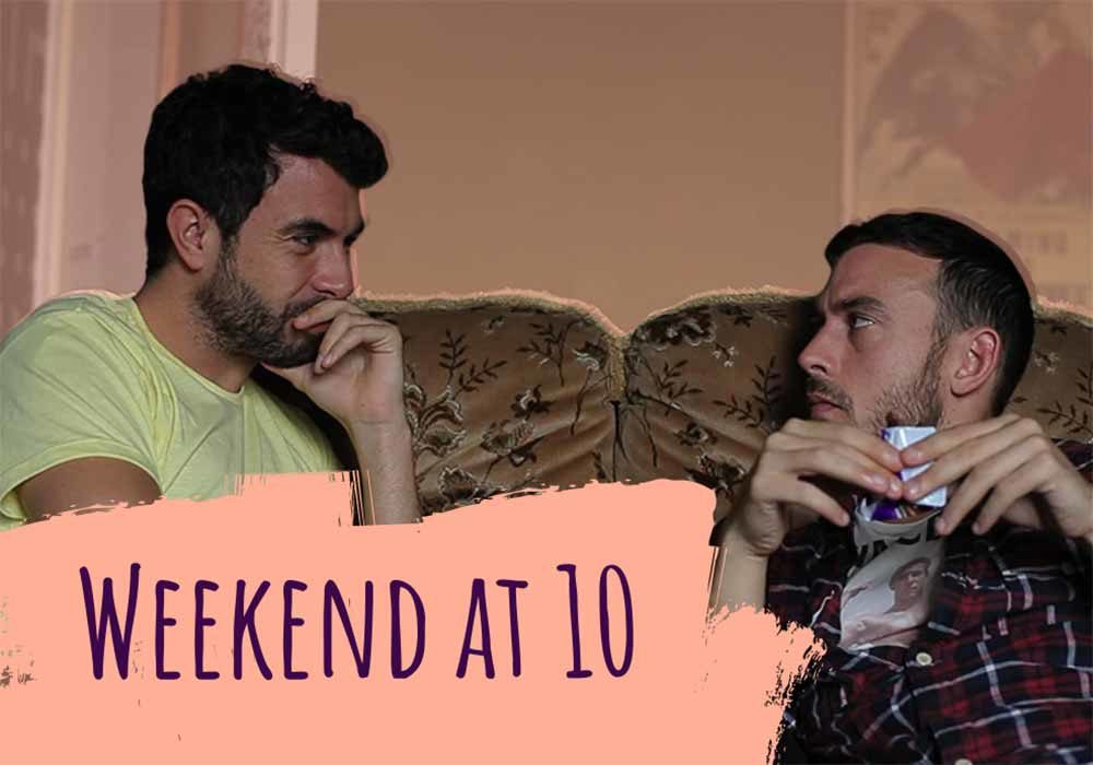 A still from Weekend, of two men sitting on an old sofa together. The text on the image reads, 'Weekend at 10'.