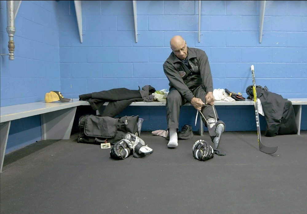 Willie O'Ree puts on his skates in Willie, directed by Laurence Mathieu-Léger

Our capsule reviews highlight six of the standouts at the 2019 Hot Docs Canadian International Documentary Festival: Conviction, Buddy, Willie, In My Blood It Runs, We Will Stand Up, and Push.