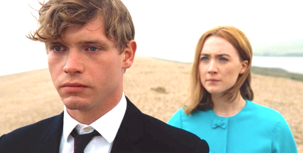 Edward faces away from Florence during the final beach confrontation scene in On Chesil Beach.