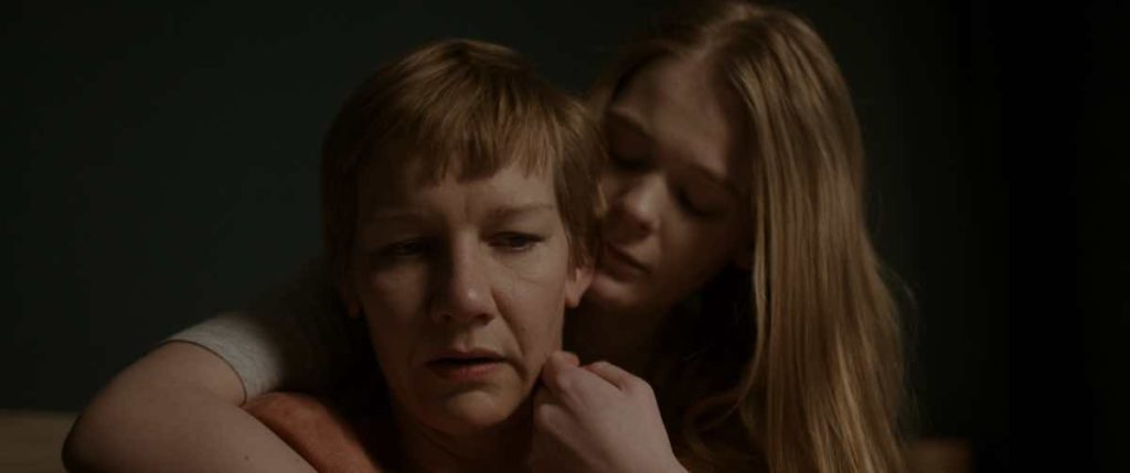Marlene (Sandra Hüller, left) is being hugged by her daughter, Mona (Gro Swantje Kohlhof, right), in the film Sleep, directed by Michael Venus, screening at Fantasia Festival.