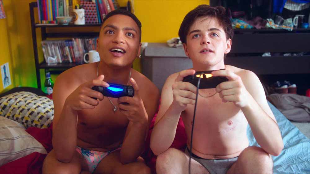 A still of two boys playing video games in their underwear in Dungarees.