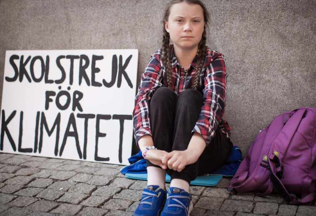 Greta Thunberg sits in front of the Swedish parliament building to strike for climate in Nathan Grossman's documentary I Am Greta. Courtesy of Mongrel Media.