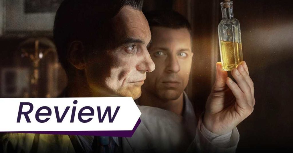 A still from Charlatan, in which a man holds up a small glass of urine to the light and stares at it, while another main watches him from behind. The text on the image says: Review.