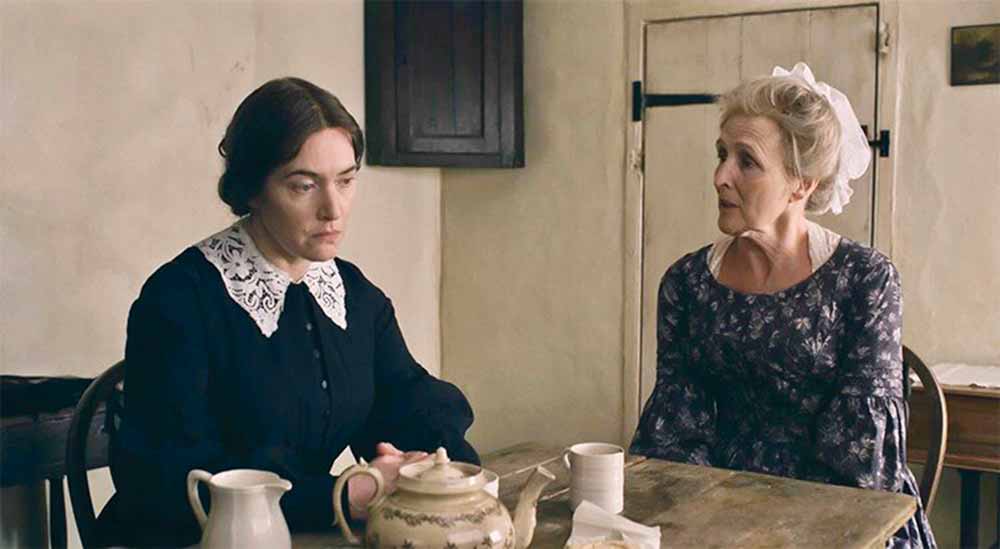 Kate Winslet and Fiona Shaw sit at a table together in Ammonite.