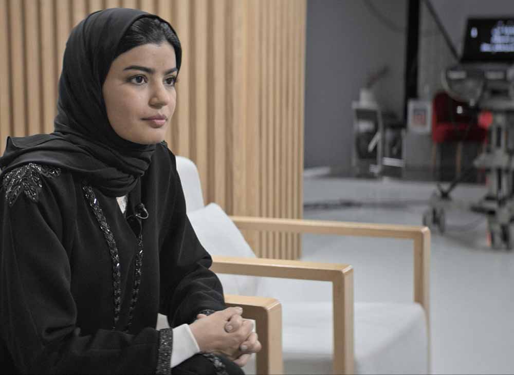Mila Al Zahrani sits on a chair in The Perfect Candidate.