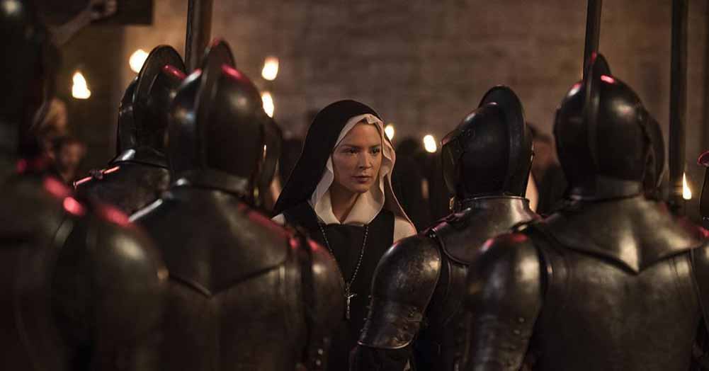 A nun faces off against a group of armed knights in Benedetta.