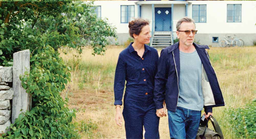 A couple walks away from a house in Bergman Island, one of our most anticipated films of 2021.