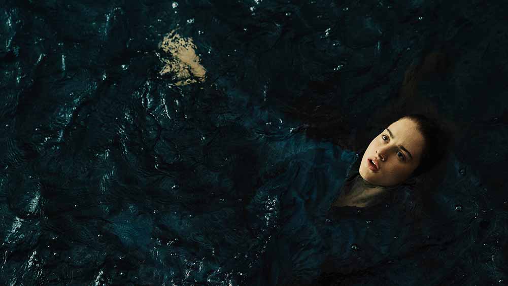 A still of Grace Van Patten in Mayday, trying to stay afloat in a great body of water.