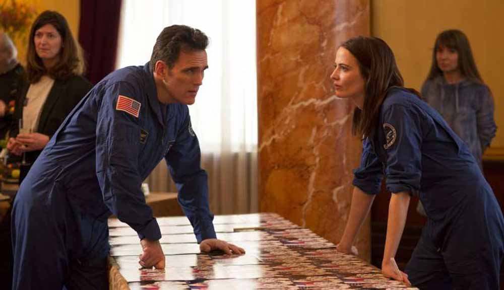 Matt Dillon speaks to Eva Green over a meeting table in Proxima.