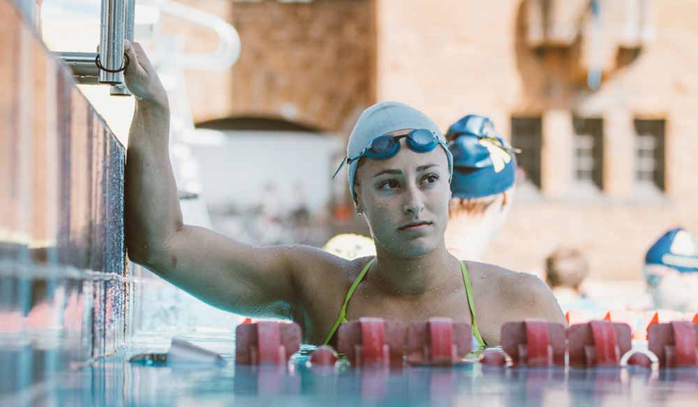 A swimmer holds onto the pool's edge in Nadia, Butterfly, one of the best Canadian films of 2020.