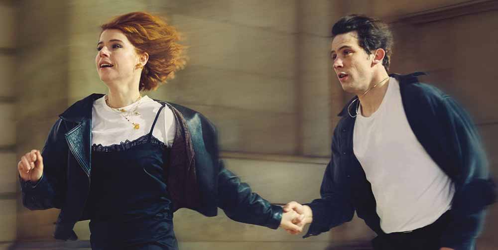 Two young people run down the street together in Romeo & Juliet, one of our most anticipated films of 2021.