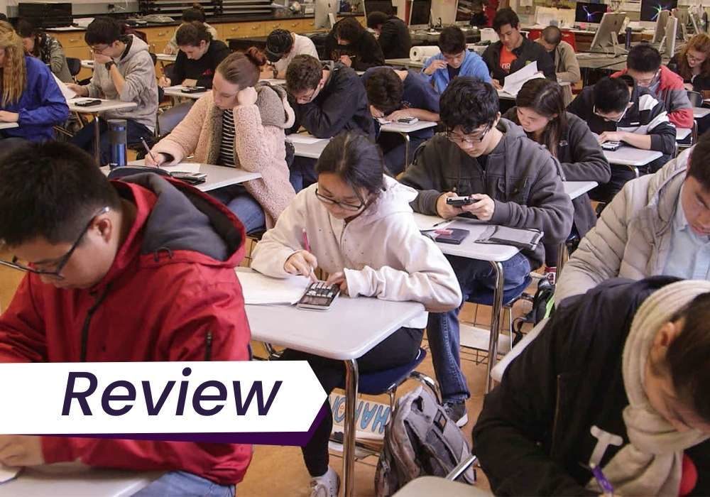 A still from Try Harder, of a group of students taking an exam. The text on the image reads, 'Interview'.