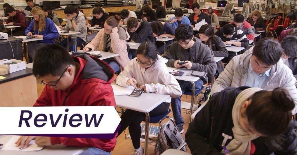 A still from Try Harder, of a group of students taking an exam. The text on the image reads, 'Interview'.