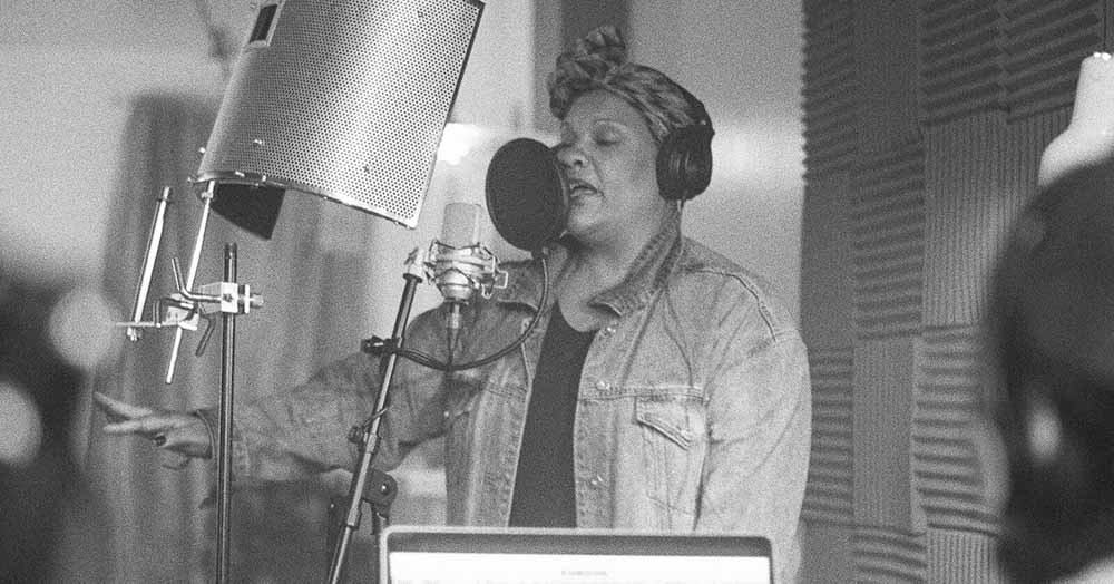 A woman records a song at a recording booth in The Forty-Year-Old Version, one of the best films of 2020.