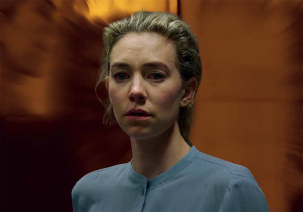 A still of Vanessa Kirby in Pieces of a Woman in front of a swirling orange background.