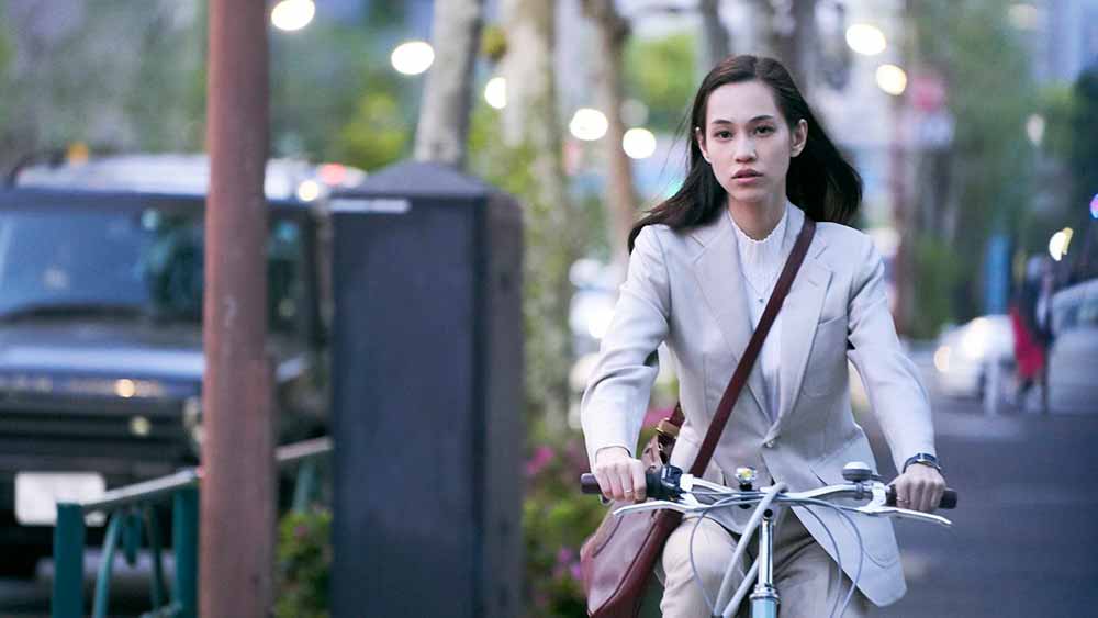 A young woman rides a bicycle through the street in Aristocrats, one of the best films of IFFR 2021.