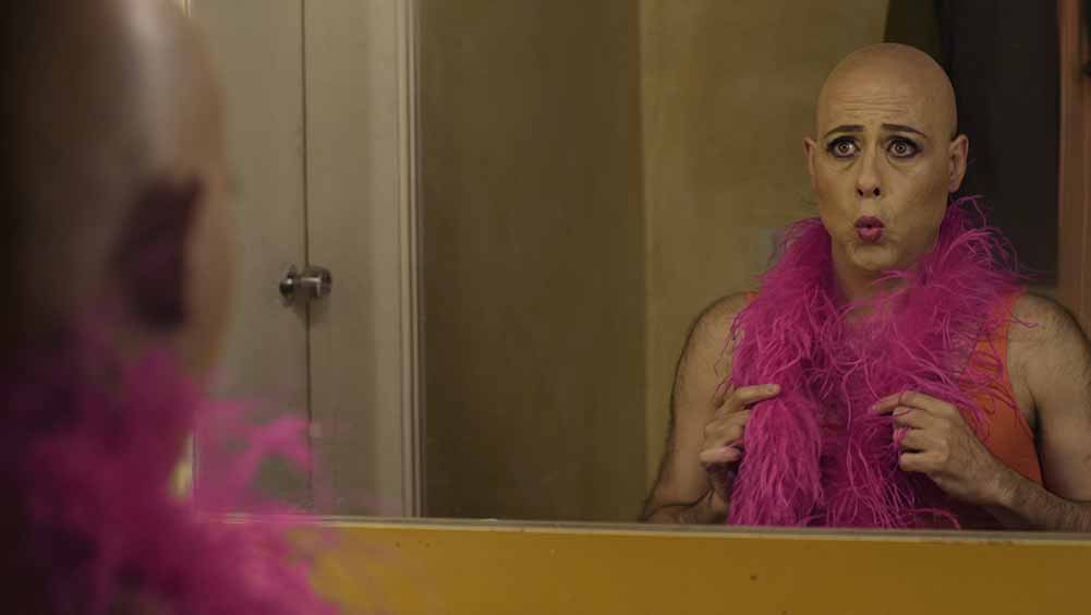 A man in light drag regards himself in the mirror in Miguel's War, one of the best films of Berlinale 2021.