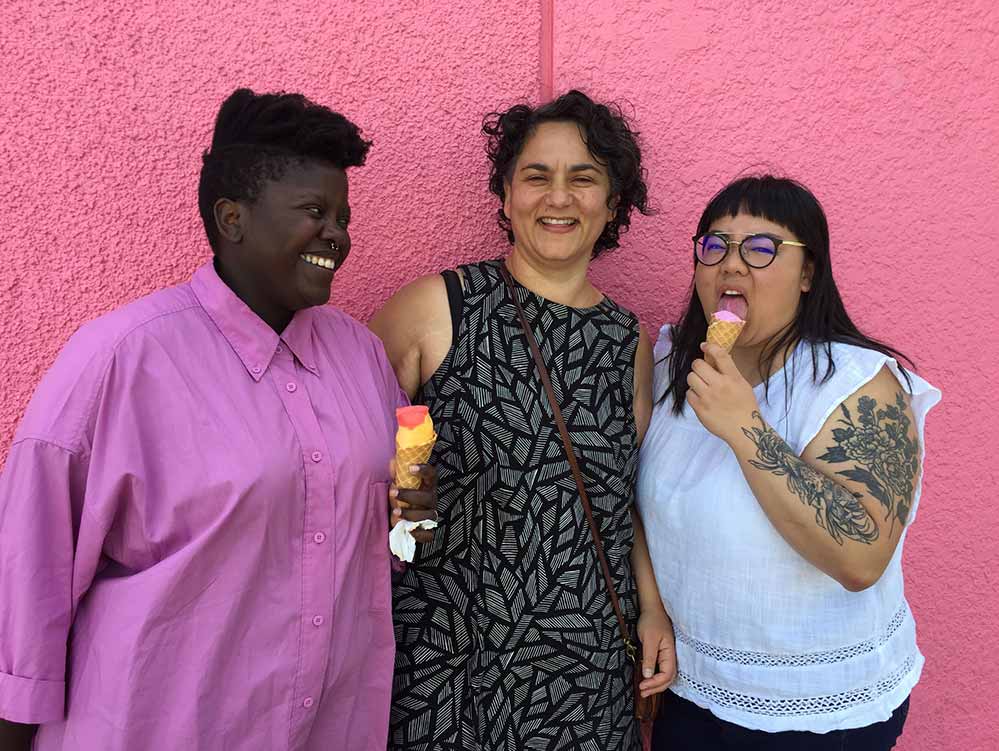 Three fat woman stand smiling, eating ice creams, against a pink background in Well Rounded, a BFI Flare 2021 film.