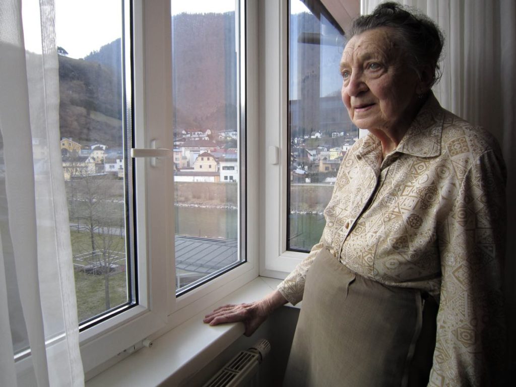 FINAL ACCOUNT by director Luke Holland, released by Focus Features. © 2021 PM Final Account Holdings, LLC. Courtesy of Focus Features LLC. Still of a member of the Third Reich in her home, looking out the window at the landscape. 