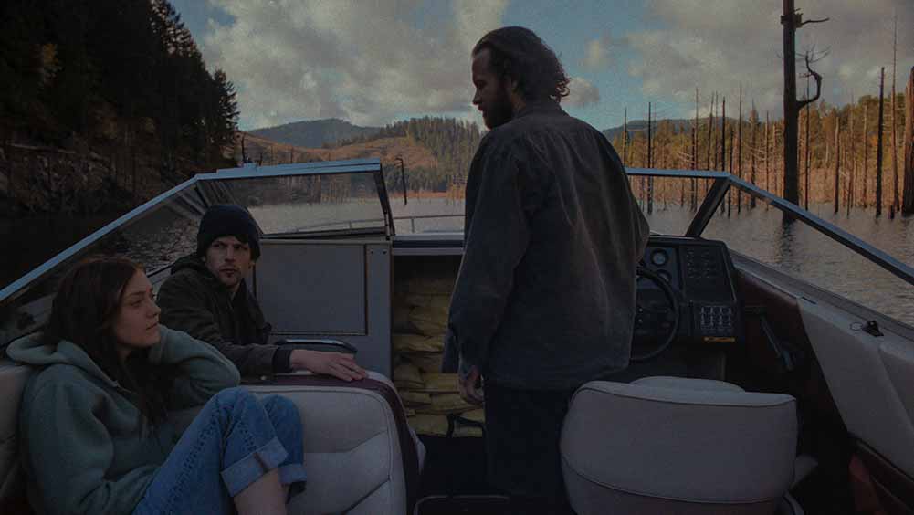 Two men and a woman sit on a small motor-powered boat in Night Moves, written by Jon Raymond.