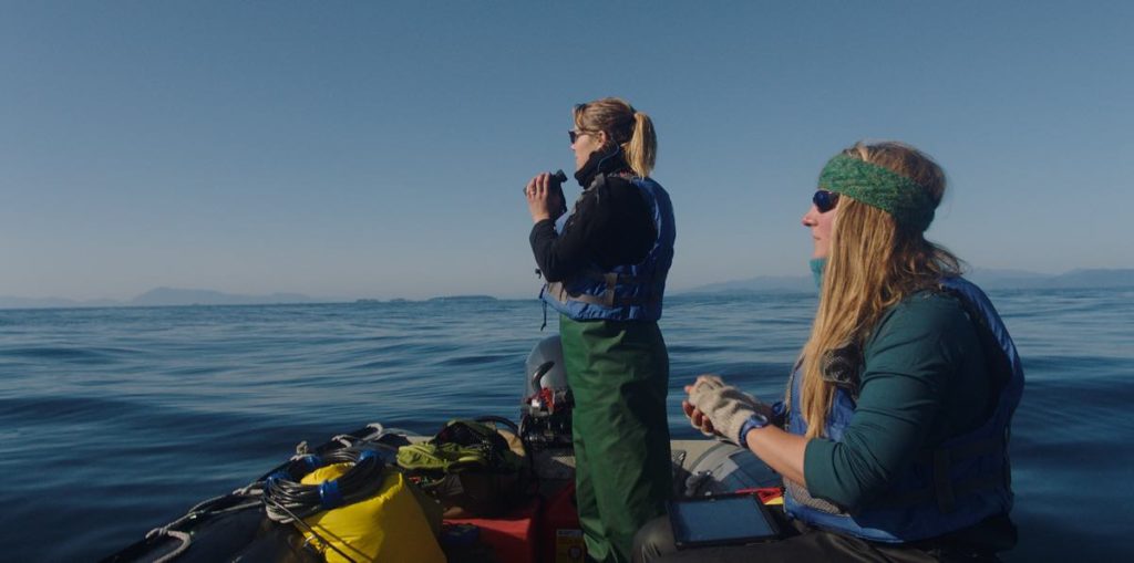Dr. Michelle Fournet and Natalie Mastick Jensen on a zodiac looking for humpback whales in Drew Xanthopoulos's documentary “Fathom,” now streaming on Apple TV+.​