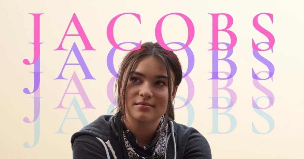 A headshot of actress Devery Jacobs from Reservation Dogs, with her latest name, 'Jacobs', written several times behind her head.