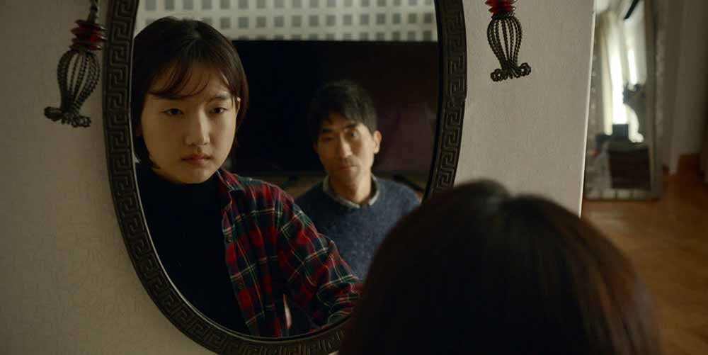 A woman and a man look into the mirror of a hotel room in Albert Shin's Together, one of the best shorts at TIFF 2021.