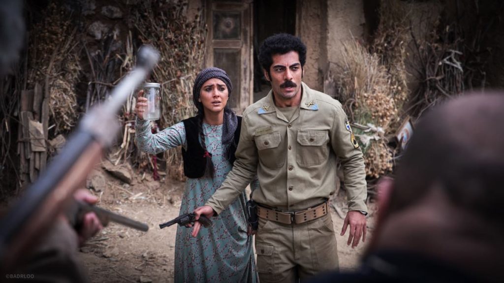 Town doctor Maliheh (Hoda Zeinolabedin) and police officer Massoud (Navid Pourfaraj), in front of the doctor’s house. Trying to Convince the villagers there are demon inside the jar. Photo by Mohammad Badrloo. 