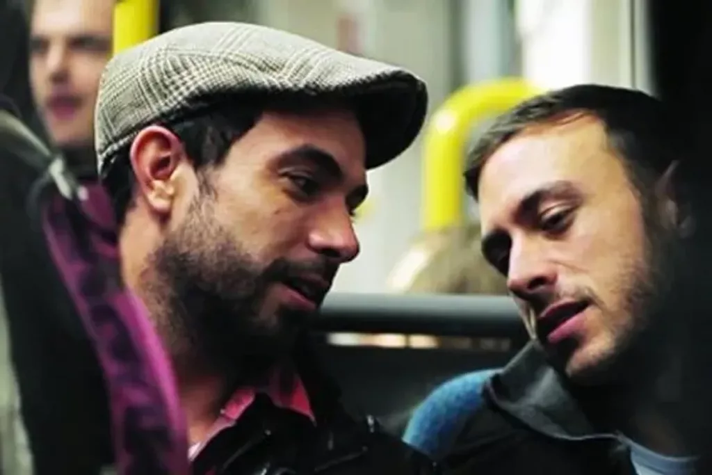 Still of Russell (Tom Cullen) and Glen (Chris New) on the tram in Nottingham in director Andrew Haigh's Weekend.