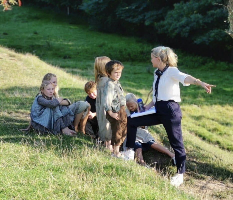 Director Tea Lindeburg on the set of As in Heaven with a group of child actors. Photo by Thomas Page.