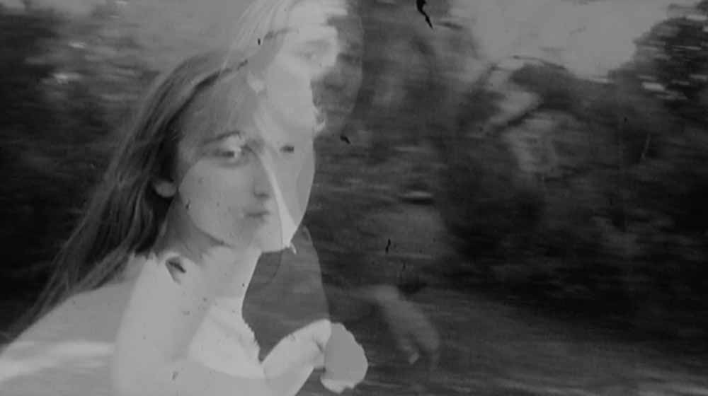 A still from Maya at 24, in which images of Lynne Sachs's daughter, Maya, are overlayed on each other in black and white.