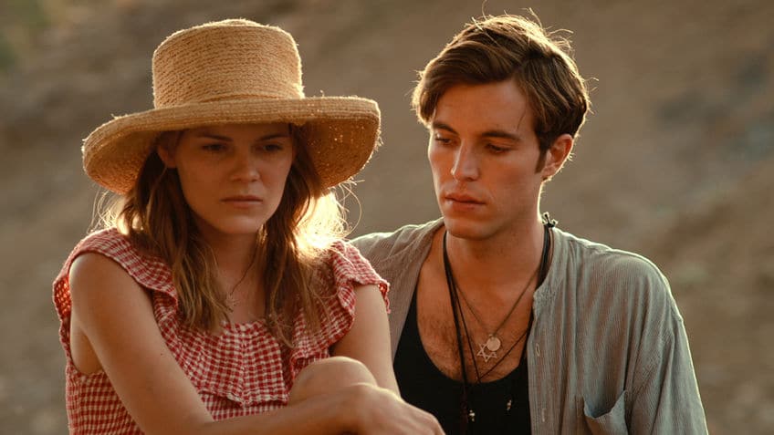 Tom Hughes stars in the "romantic adventure" Dare to Be Wild, wearing many necklaces