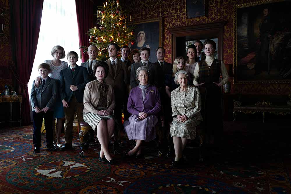 A still from Spencer, in which the entire royal family is pictured together in a wide shot, posing for a family photo.