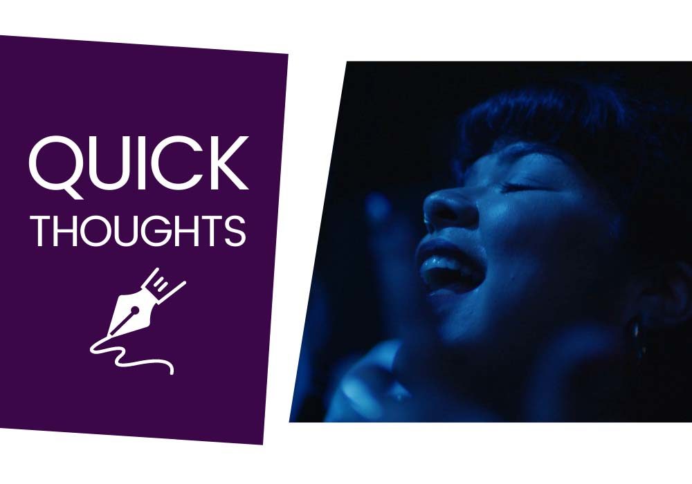 A still from Mija, in which a young woman, Doris, sings her heart out, bathed in deep blue light. Next to the still is a purple box featuring white text, which reads, 'Quick thoughts.'