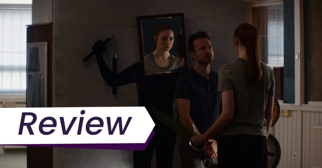 Aaron Paul (left) stars in Dual, directed by Riley Stearns, as a self-defense duel trainer hired by Sarah played by Karen Gillan (right). Sarah is looking at herself in the mirror to imagine what it would be like to be attacked (and to kill) her clone.