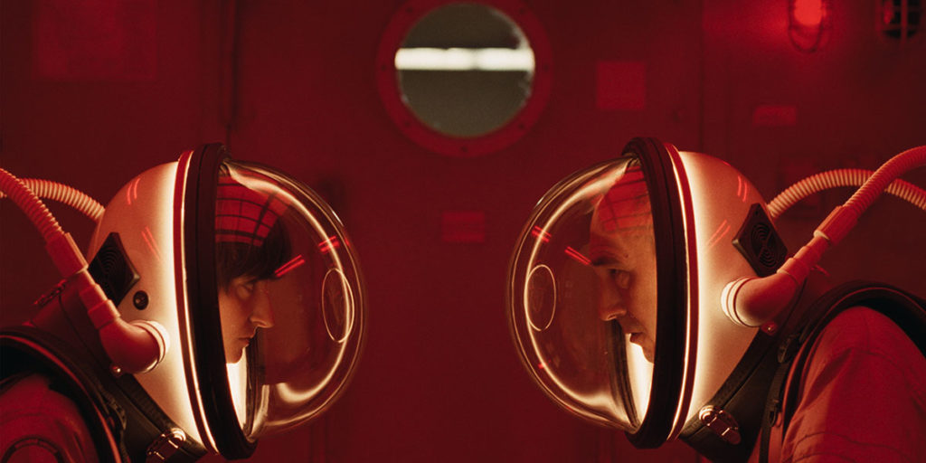 Steven (a woman) and David wear their red space suits in the airlock and have a private conversation in a scene with many homages to 2001: A Space Odyssey. Stéphane Lafleur discusses how 2001 influenced the film Viking in this interview. Photo courtesy of TIFF.
