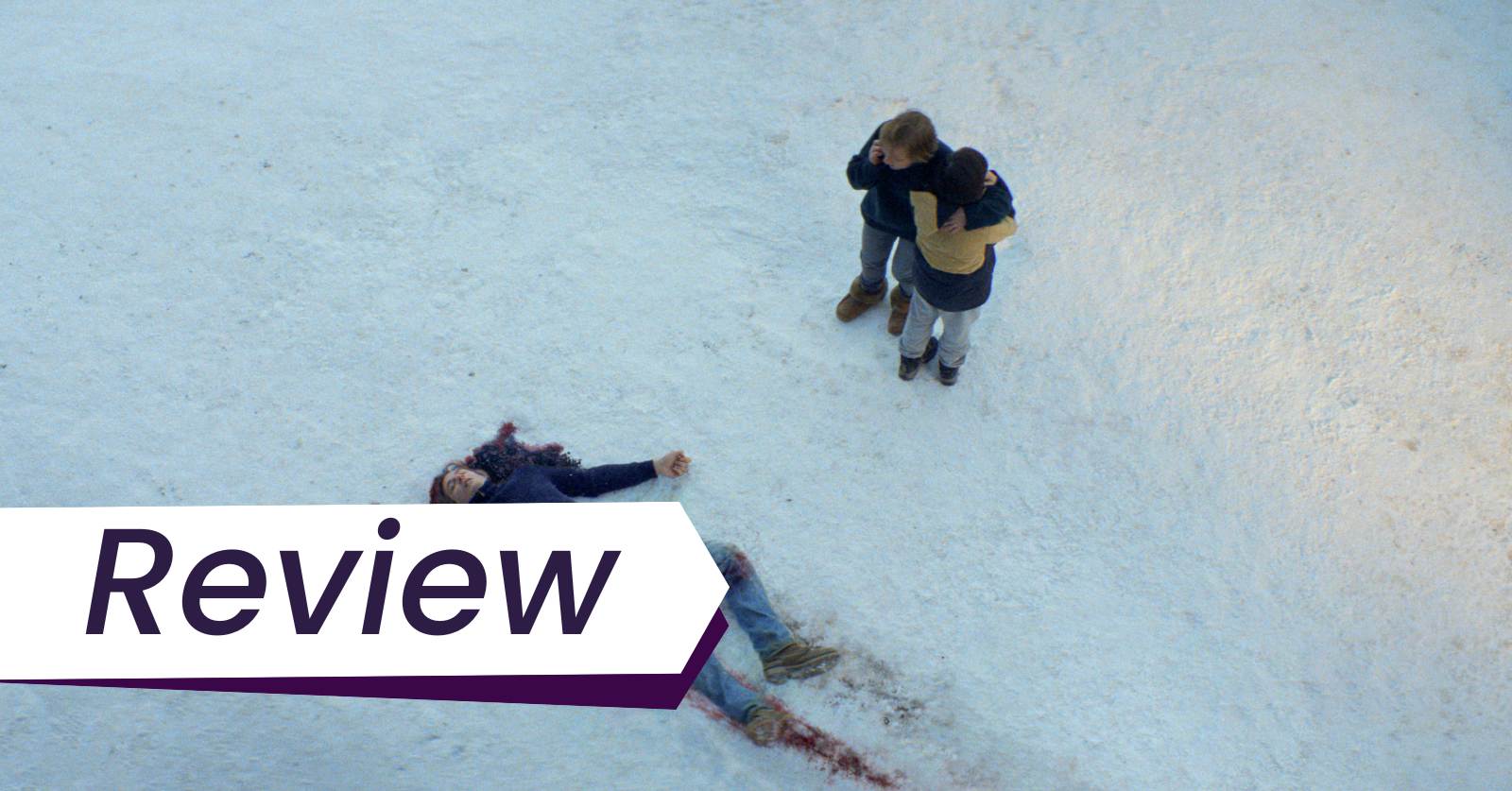 Sandra (Sandra Hüller, right, on the phone) hugs her son, turned away, while looking at her dead husband on the snowy ground, bleeding from the head in Justine Triet's film Anatomy of a Fall.