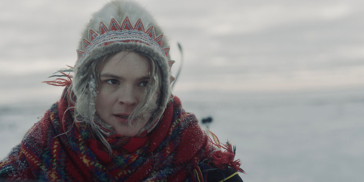 A blonde woman dressed in a traditional Sámi hat and scarf stars in The Tundra Within Me, one of the best acquisition titles at TIFF 2023.